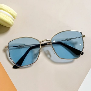 Fashionable oversized kids sunglasses with blue lenses and gold frames on colorful background
