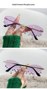 Détail de lunettes de soleil à monture dorée avec verres violets en forme de larmes