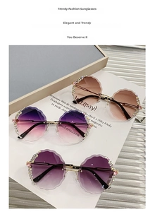 Close-up of rimless round sunglasses with flower petal edges and colorful rhinestones