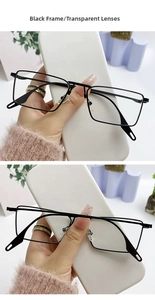 Detail shot of black rectangular metal sunglasses frame with clear transparent lenses