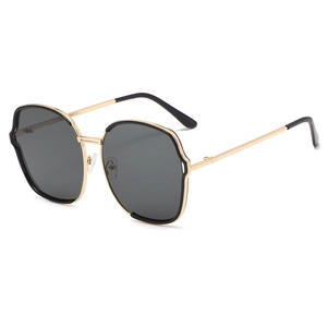 Lunettes de soleil hexagonales oversize avec monture en métal doré et verres noirs