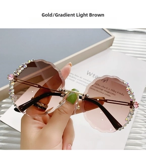 Detail of rimless round sunglasses with flower rhinestones and gradient brown lenses