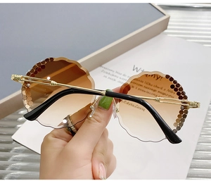 Detail of rimless wave-petal lenses with brown gradient and sparkling rhinestone trim