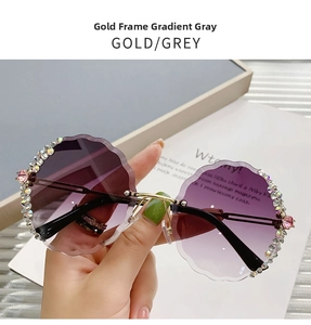 Close-up of rimless gradient purple sunglasses with flower diamond trim and gold frame