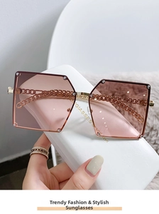 Detail of pink gradient hexagonal sunglasses with gold chain and rhinestone accents