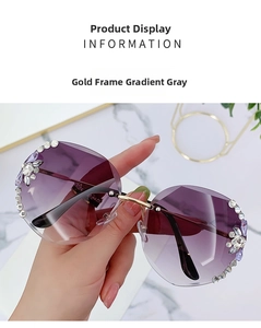Detail of rimless gold sunglasses with gradient purple lenses and rhinestone flowers