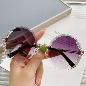 Frameless round sunglasses with purple gradient lenses and floral crystal rhinestone trim