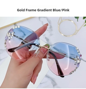 Close-up of rimless gradient blue pink sunglasses with floral rhinestone detailing