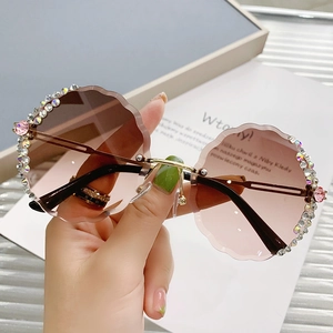Luxury rimless round sunglasses with crystal floral edges and brown gradient lenses