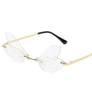 Frameless dragonfly wing sunglasses with gold metal frame and transparent lenses