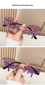 Detail of purple rimless sunglasses with dangling teardrop rhinestones on gold metal frames