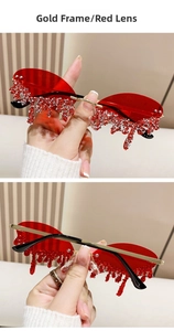 Detail of rimless angel tear sunglasses with gold frame and red crystal droplets