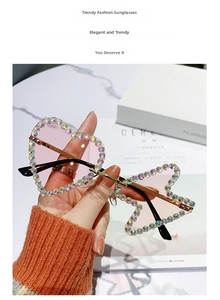Detailed macro view of heart-shaped rimless sunglasses with gradient pink lenses and AB crystals