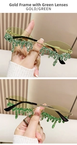 Detail of gold rimless sunglasses with green lenses and teardrop rhinestone pendants