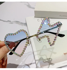Detail of heart-shaped rimless sunglasses with gradient lenses and rainbow rhinestones