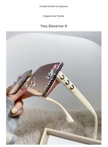 Detail of luxury rimless sunglasses with gradient lenses and rhinestone floral accents