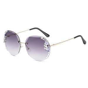 Frameless purple gradient sunglasses with rhinestone flower accents and gold metal temples