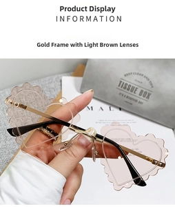 Close-up of gold rimless heart-shaped sunglasses with brown gradient lenses and wavy edges