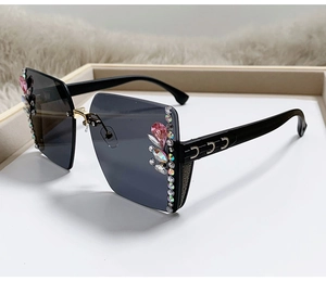 Detail of rimless gradient sunglasses with pink rhinestones and gold decorative temples