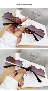 Close-up of scalloped heart sunglasses with gold frame and gradual grey lenses