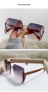 Detailed view of luxury rimless sunglasses with pink gradient lenses and colorful rhinestones