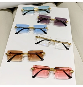Detail of luxury rimless sunglasses set with gold metal temples in six various lens colors