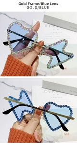 Detailed view of rimless heart and star sunglasses with gold frame and blue lenses