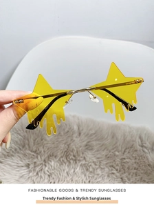 Macro shot of yellow star-shaped rimless sunglasses with liquid drip edge and gold temples