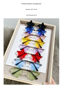 Flat lay of star-shaped teardrop rimless sunglasses in eight different vibrant lens colors