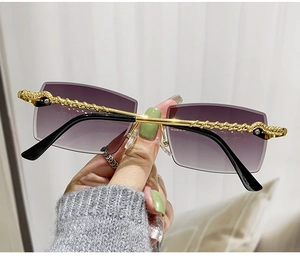 Detailed view of luxury gold braided temples and purple gradient lenses on rimless sunglasses