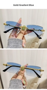 Detail of gold snake-style temple with panther emblem and gradient blue lenses