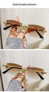 Close-up of golden braided metal temples and gradient brown lenses on rimless sunglasses