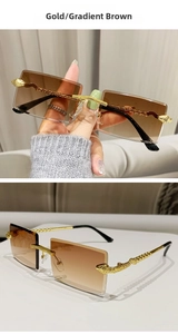 Detail of snake-shaped golden temple and brown gradient lens on rimless sunglasses