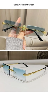 Detail of rimless rectangle sunglasses featuring golden snake temple and gradient green lens