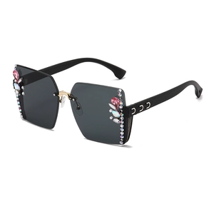Fashionable rimless grey oversized sunglasses with pink crystals and colorful rhinestones