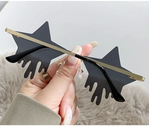Detail of star-shaped sunglasses with unique liquid drop effect and gold metal frames