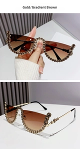Detail of gold metal half-frame sunglasses with gradient tea lenses and brown rhinestones