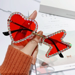 Frameless rhinestone sunglasses with heart and star-shaped red lenses for parties