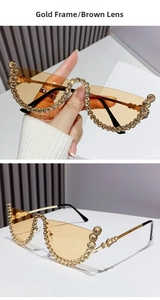 Detail of gold half-frame cat eye sunglasses with rhinestones and brown lenses