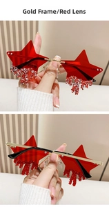 Detail of rimless star sunglasses with gold frame, red lenses and dripping crystal accents