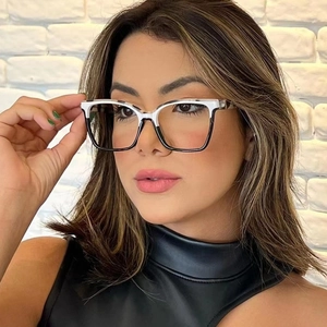 Close-up of stylish black and white TR90 glasses frames worn on a model with white wall background