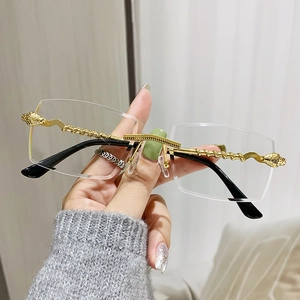 Handheld view of trendy rimless square sunglasses with gold snake-patterned metal frame