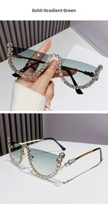 Detail of gold cat-eye sunglasses with gradient green lenses and crystal embellishments