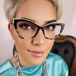 Close-up of cat-eye glasses with black and tortoiseshell frame on a female model