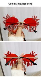 Detail of gold frame rimless sunglasses with red teardrop lenses and rhinestones