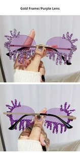 Detailed macro view of gold-rimmed teardrop sunglasses with purple rhinestones