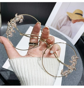 Close-up of frameless rimless sunglasses with sparkling diamond rhinestone edges and gold frame