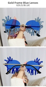 Detail of rimless teardrop sunglasses with gold frame, blue lenses and sparkling rhinestones