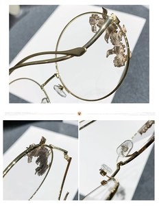 Detail of vintage gold metal rimless frame with intricate animal carving and rhinestones