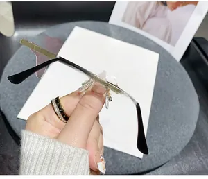 Detail of rimless 2024 New Year sunglasses featuring creative KISS letter shaped lenses